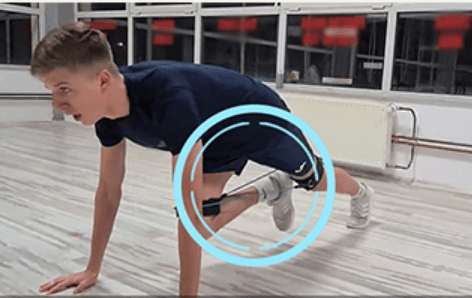 Athlete doing a Mountain Climbers exercise wearing Kinetic-BANDS resistance straps